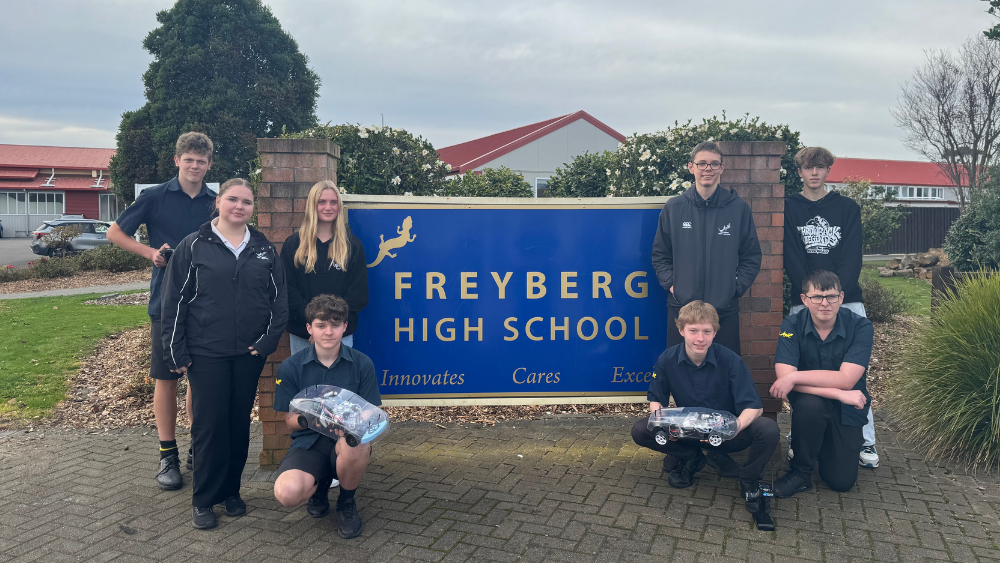 Freyberg High School students with their hydrogen remote controlled car and The Gas Hub's car.