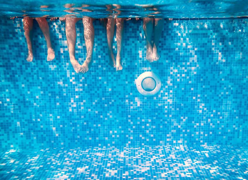 Kids feet underwear in a pool.