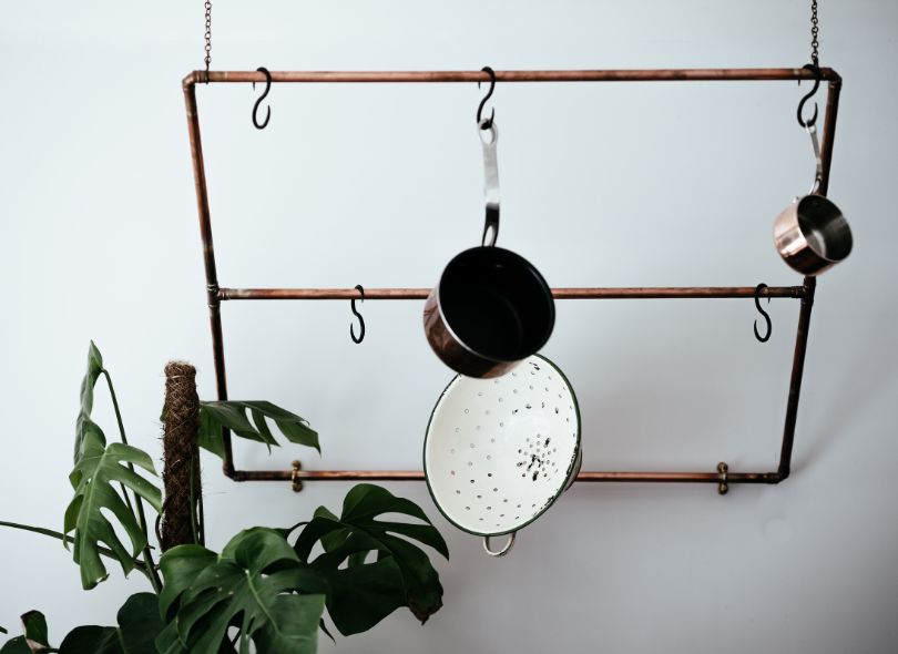 Pots hanging on kitchen wall.