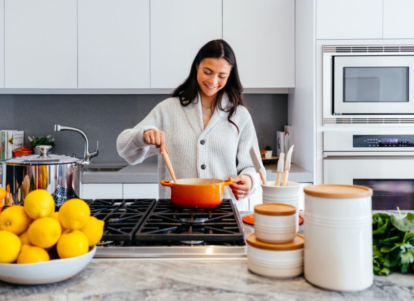 Woman cooking with gas in her kitchen.