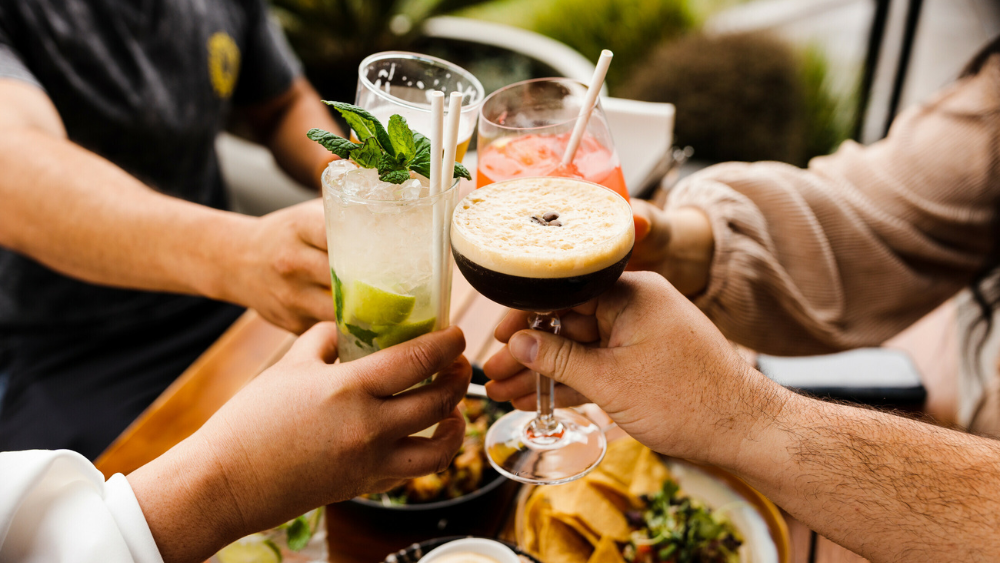 Friends cheersing over dinner.