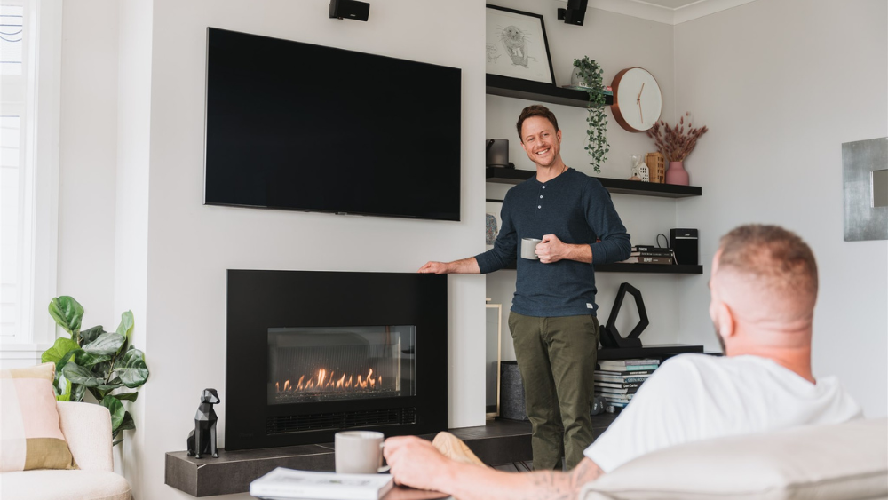 Two people enjoying the heat from a natural gas fire.