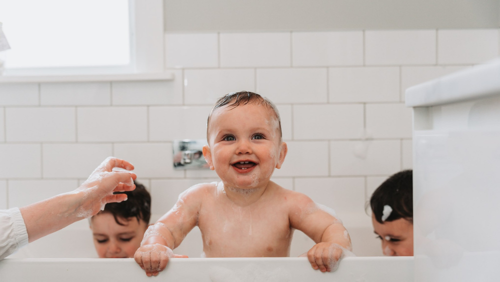 Youngs children enjoying a bath heated by natural gas.